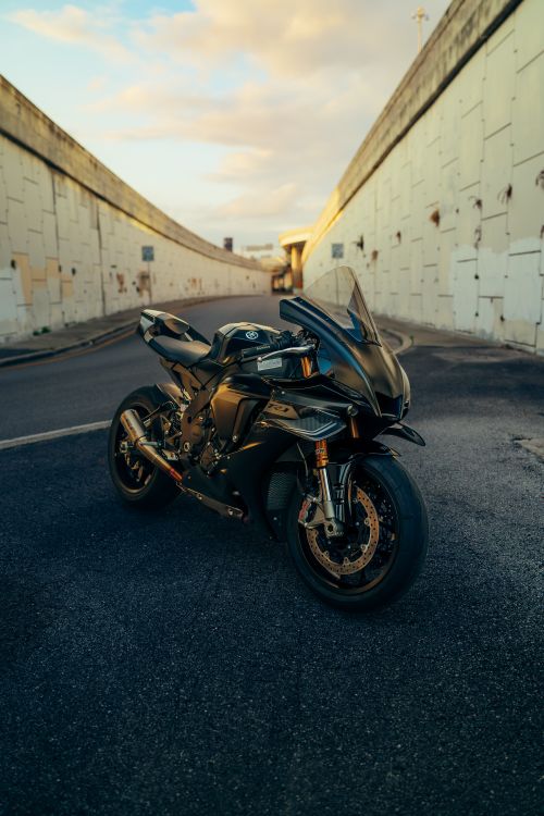 Free A sleek sport motorcycle parked in an urban tunnel at sunset. Stock Photo