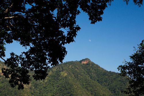 Free Scenic view of a mountain with a daytime moon over Tha Kradan, Kanchanaburi, Thailand. Stock Photo