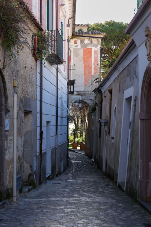 Free Explore the quaint charm of an Italian village with its narrow cobblestone alleyways and unique architecture. Stock Photo