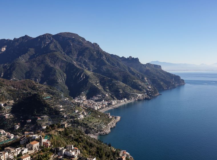 Rugged Amalfi coastline where mountains meet clear water