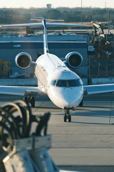A commercial jet ready for taxiing at a bustling airport during daylight.