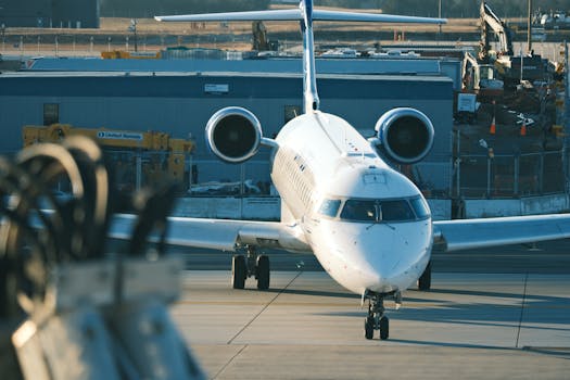 Front view of a commercial jet on the tarmac at an airport surrounded by construction.