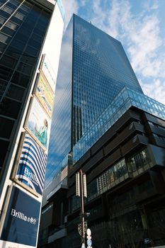 High-rise office buildings in Tokyo's vibrant cityscape on a clear day.
