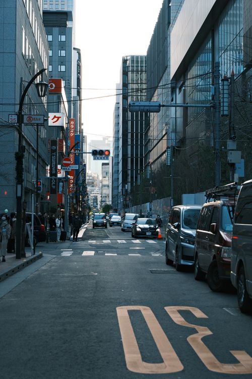 Free Moody urban street scene in Tokyo with skyscrapers and cars during dusk. Stock Photo