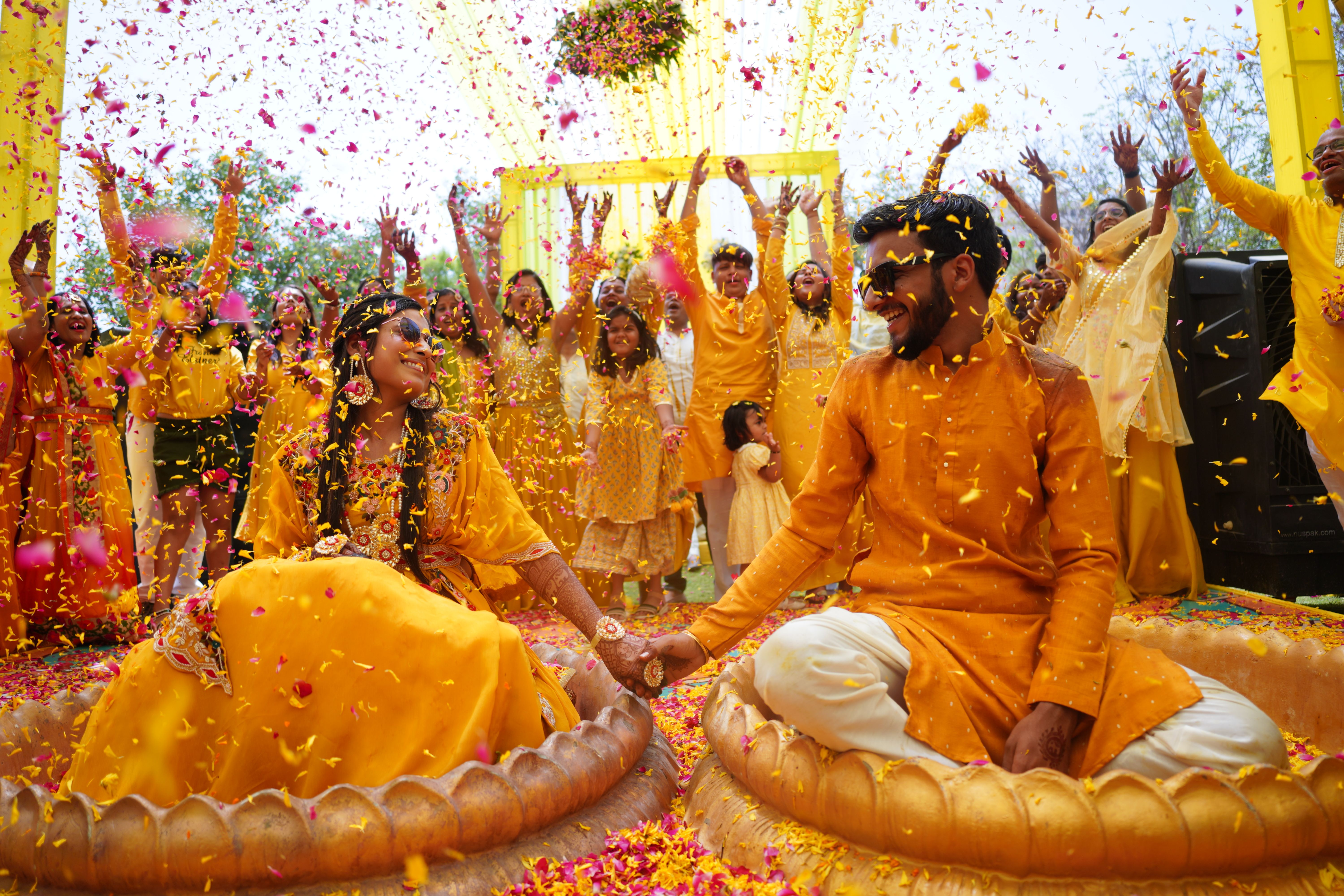 Indian couple and guests celebrating a haldi ceremony