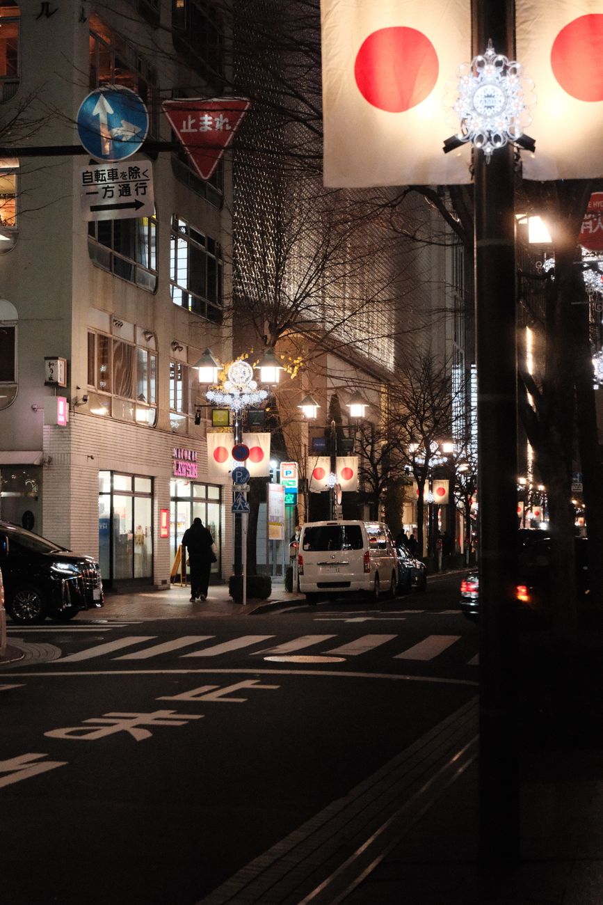 Explore the vibrant nightlife in Chuo City, Tokyo, with colorful street lights and bustling urban life.