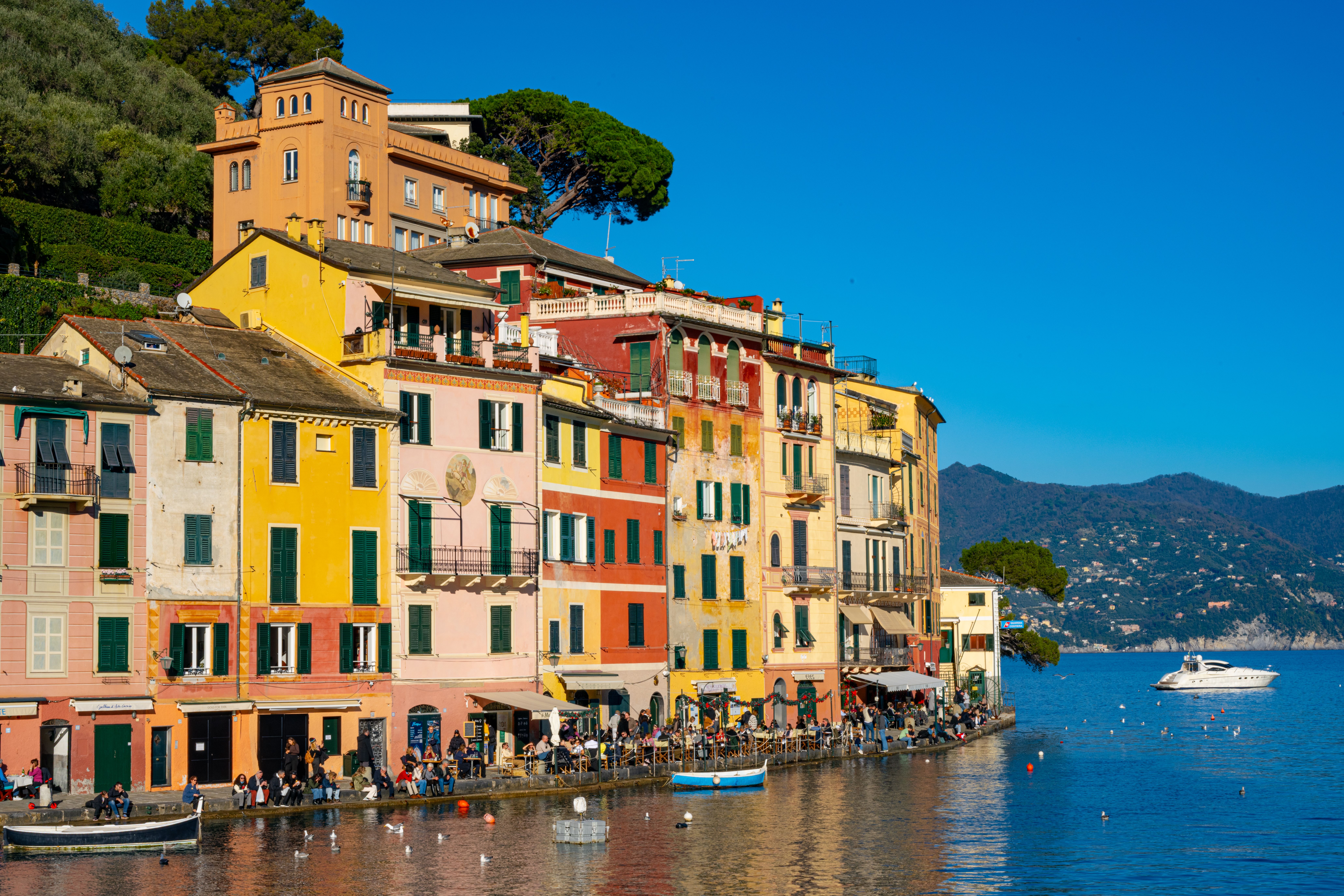 Vibrant seafront buildings in Portofino, Italy with a scenic coastal view.