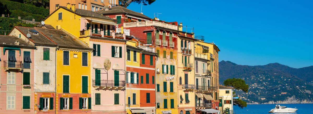 Vibrant seafront buildings in Portofino, Italy with a scenic coastal view.