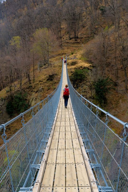 Free A person crossing a scenic suspension bridge in Switzerland. Stock Photo