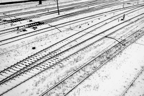 Free Aerial view of snowy railway tracks in Lviv, capturing the serene winter landscape Stock Photo
