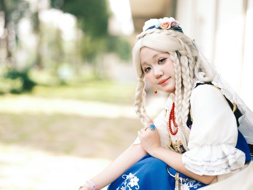 Free Cosplayer in detailed costume posing outside with braided hair and floral accessories. Stock Photo