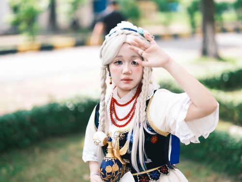 Free A young adult in elaborate cosplay with braided hair and anime-inspired costume outdoors. Stock Photo