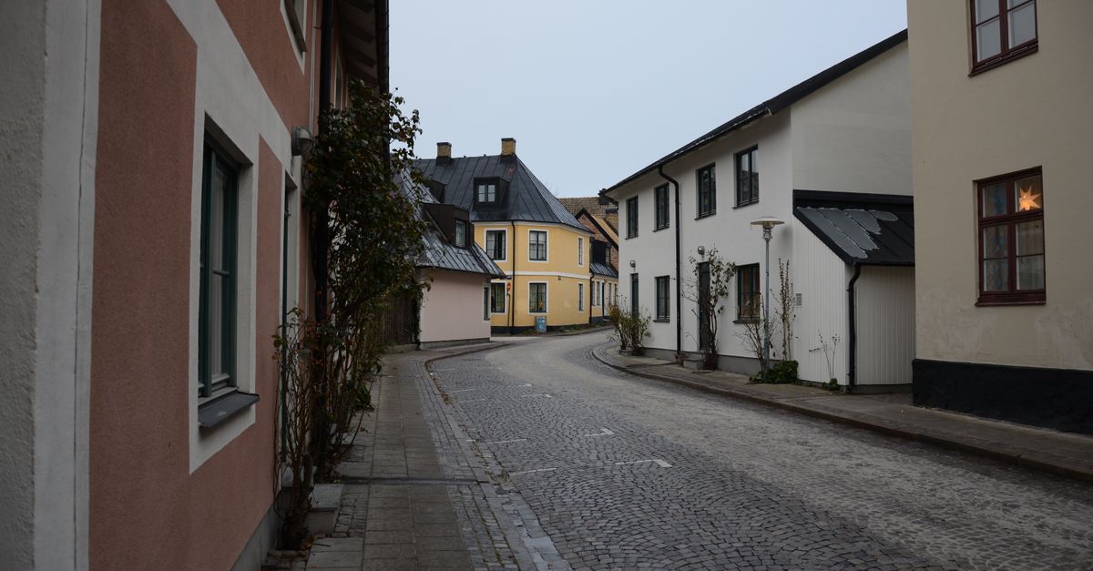 panoramic view of a quiet European city with cobblestone streets and pastel buildings, no crowds