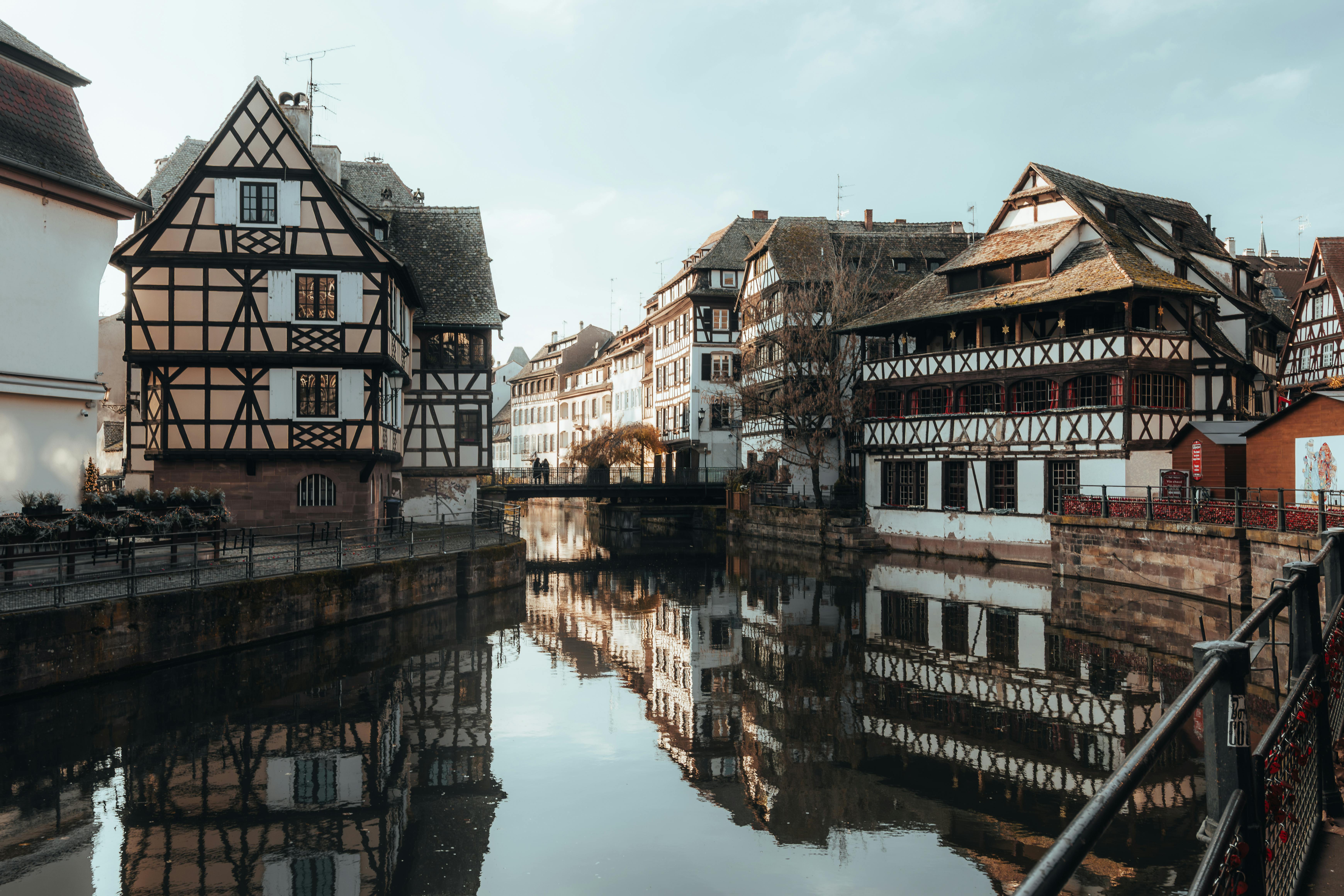 Picturesque view of half-timbered houses reflected in a canal, Strasbourg, France.