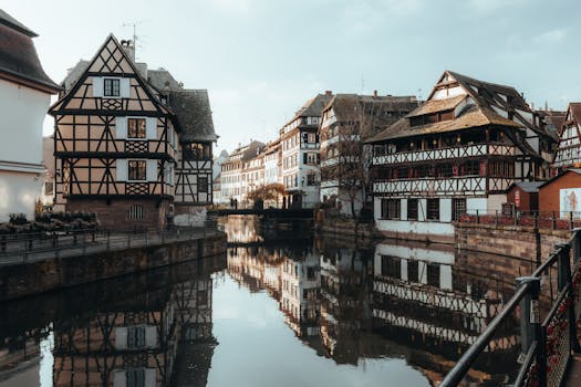 Picturesque view of half-timbered houses reflected in a canal, Strasbourg, France.