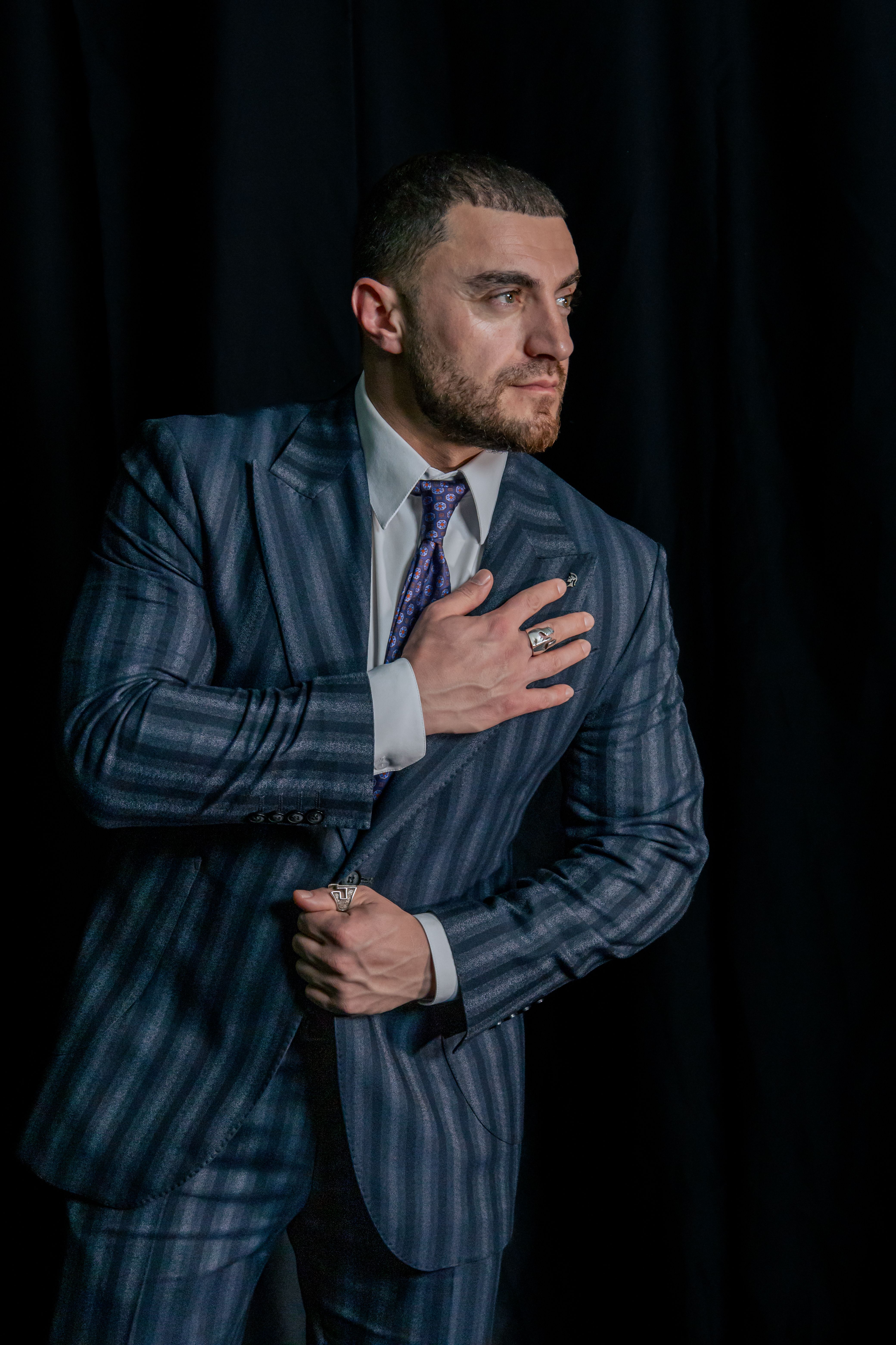 Stylish Man in Suit with Rings and Tie