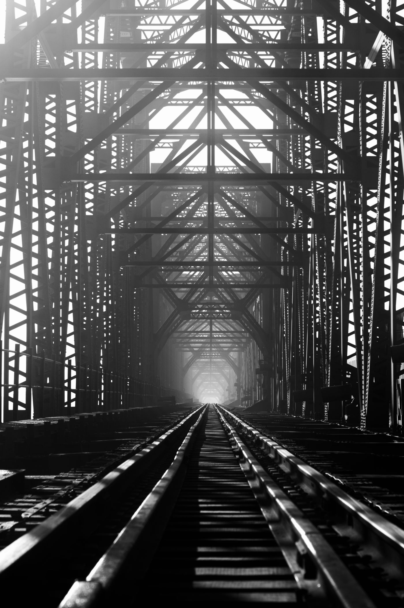 A steel truss bridge in monochrome. Photo by RATUL KHAN on Pexels