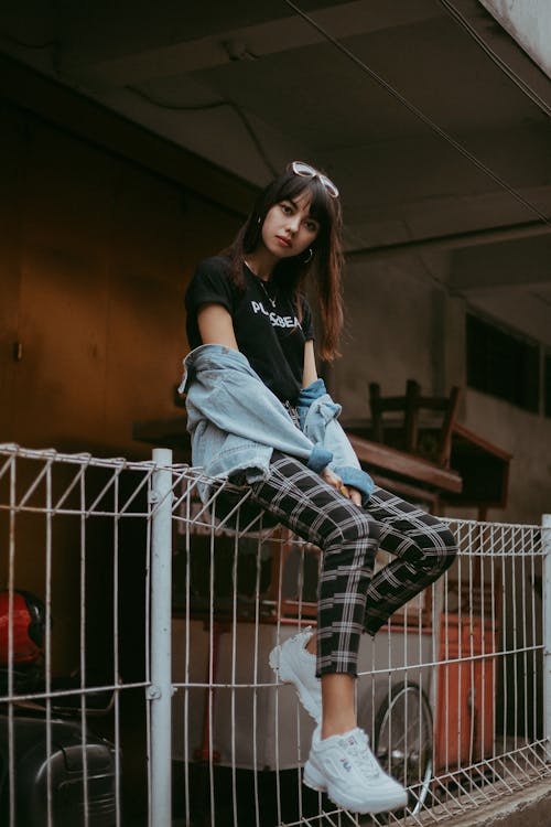 Woman Sitting on Fence