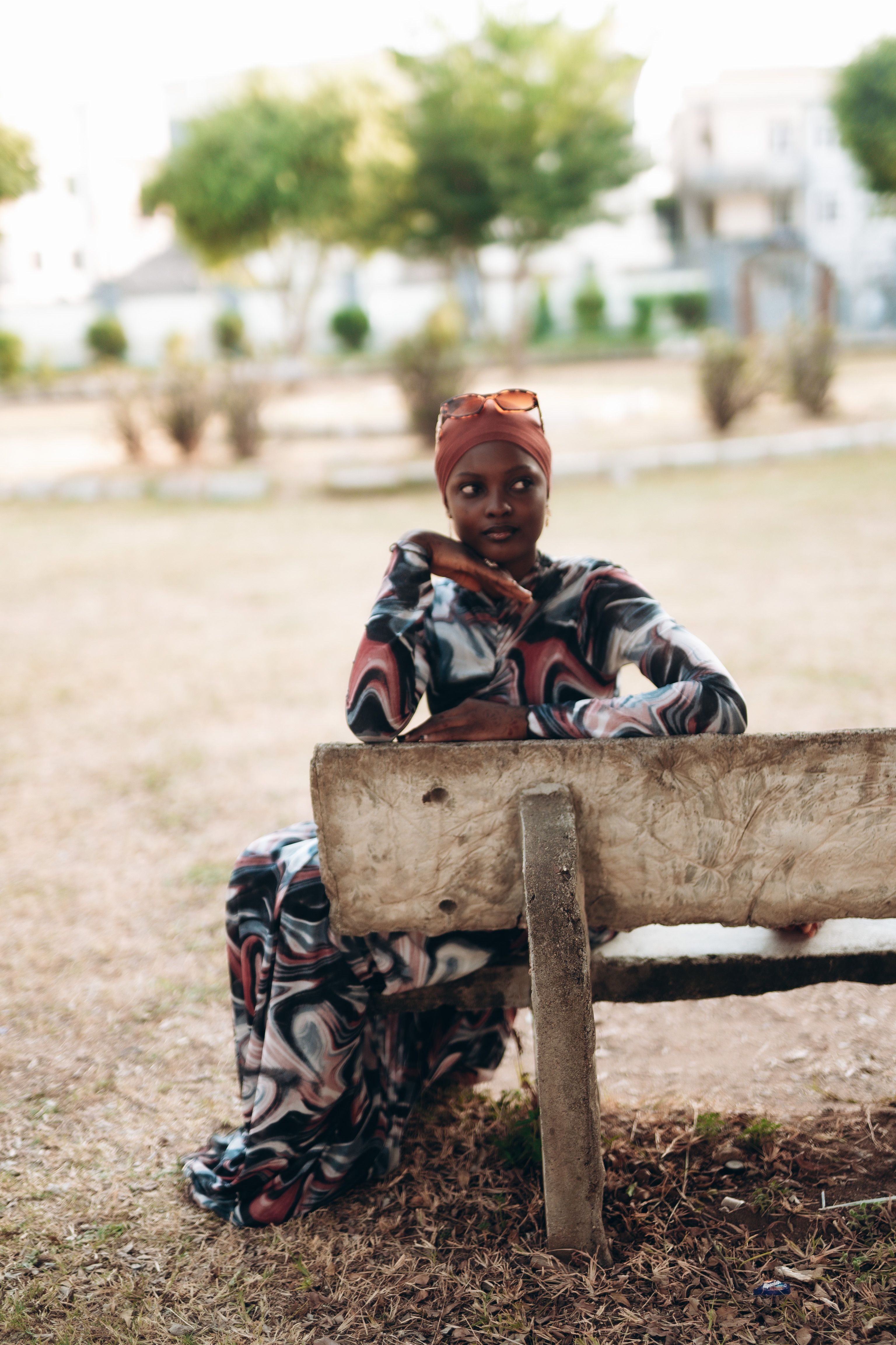 Elegant Woman Sitting on Park Bench Outdoors · Free Stock Photo