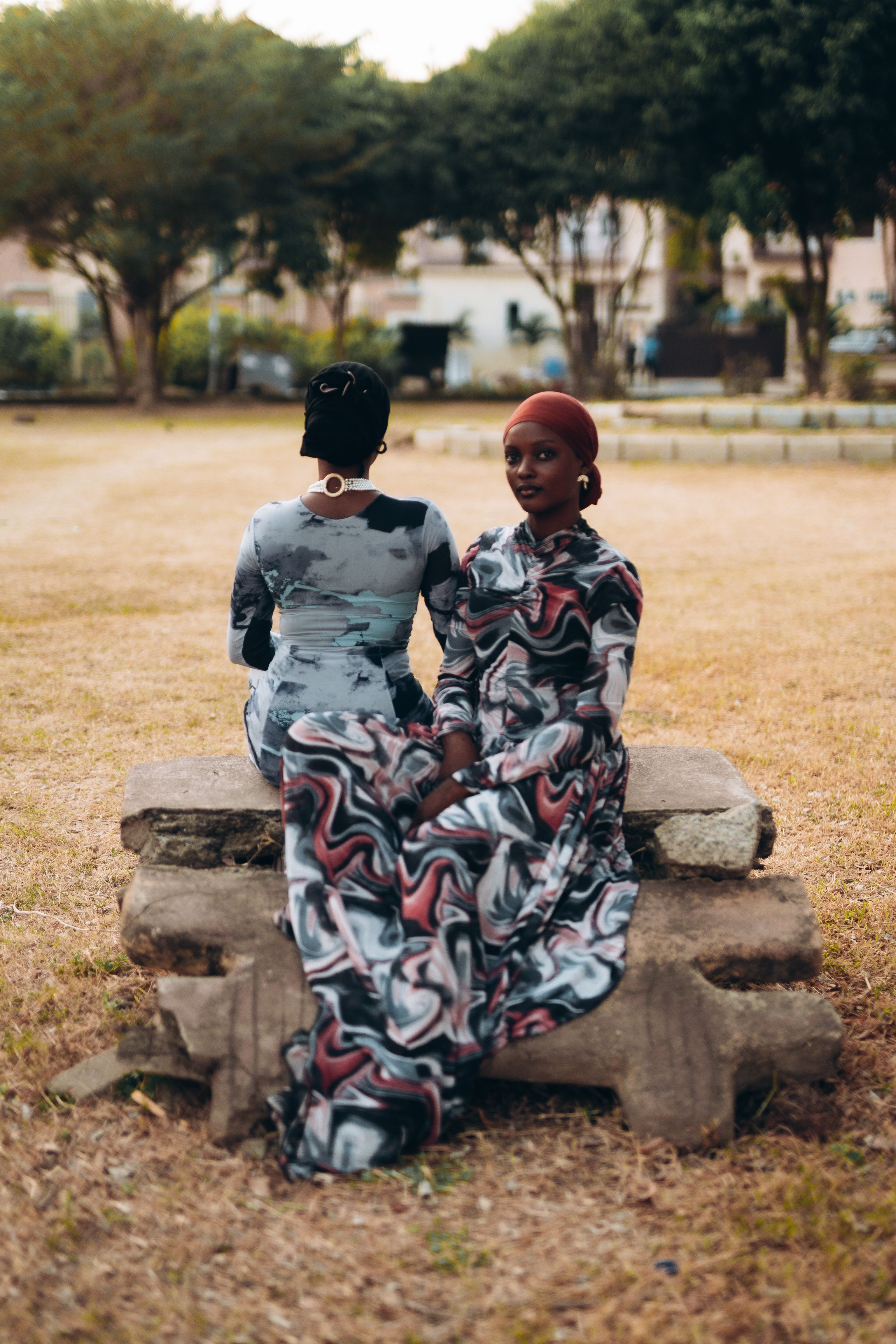 Elegant Women Posing Outdoors in Stylish Dresses · Free Stock Photo