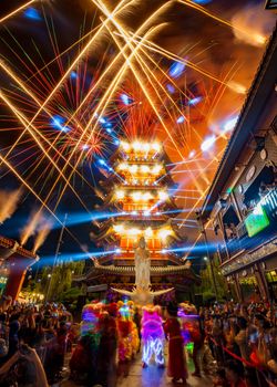 Colorful fireworks illuminate a traditional pagoda during a celebration in Indonesia.