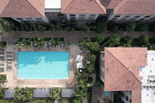 An aerial shot of a modern apartment complex pool in Los Angeles, showcasing urban living.