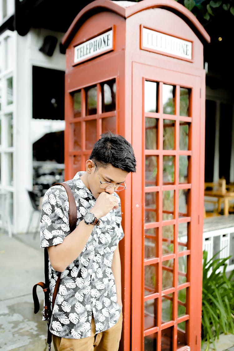 Stylish Pensive Guy Near Phone Booth