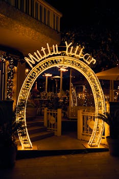Brightly lit arch with 'Mutlu Yıllar' for New Year celebration.