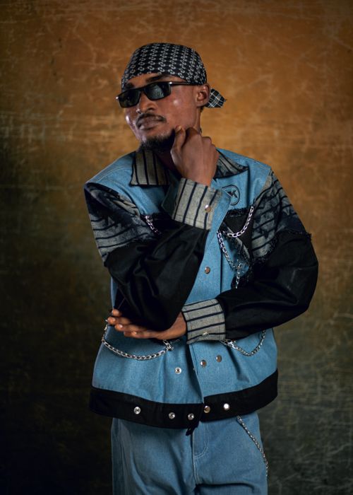 Free Portrait of a young man wearing a denim jacket and sunglasses with a thoughtful pose. Stock Photo