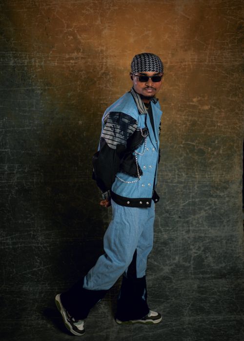 Free Fashionable man in denim jacket and sunglasses posing in studio. Stock Photo