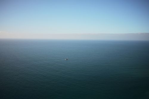 Free Peaceful ocean view with a lone boat, captured from Madeira, Portugal. Stock Photo
