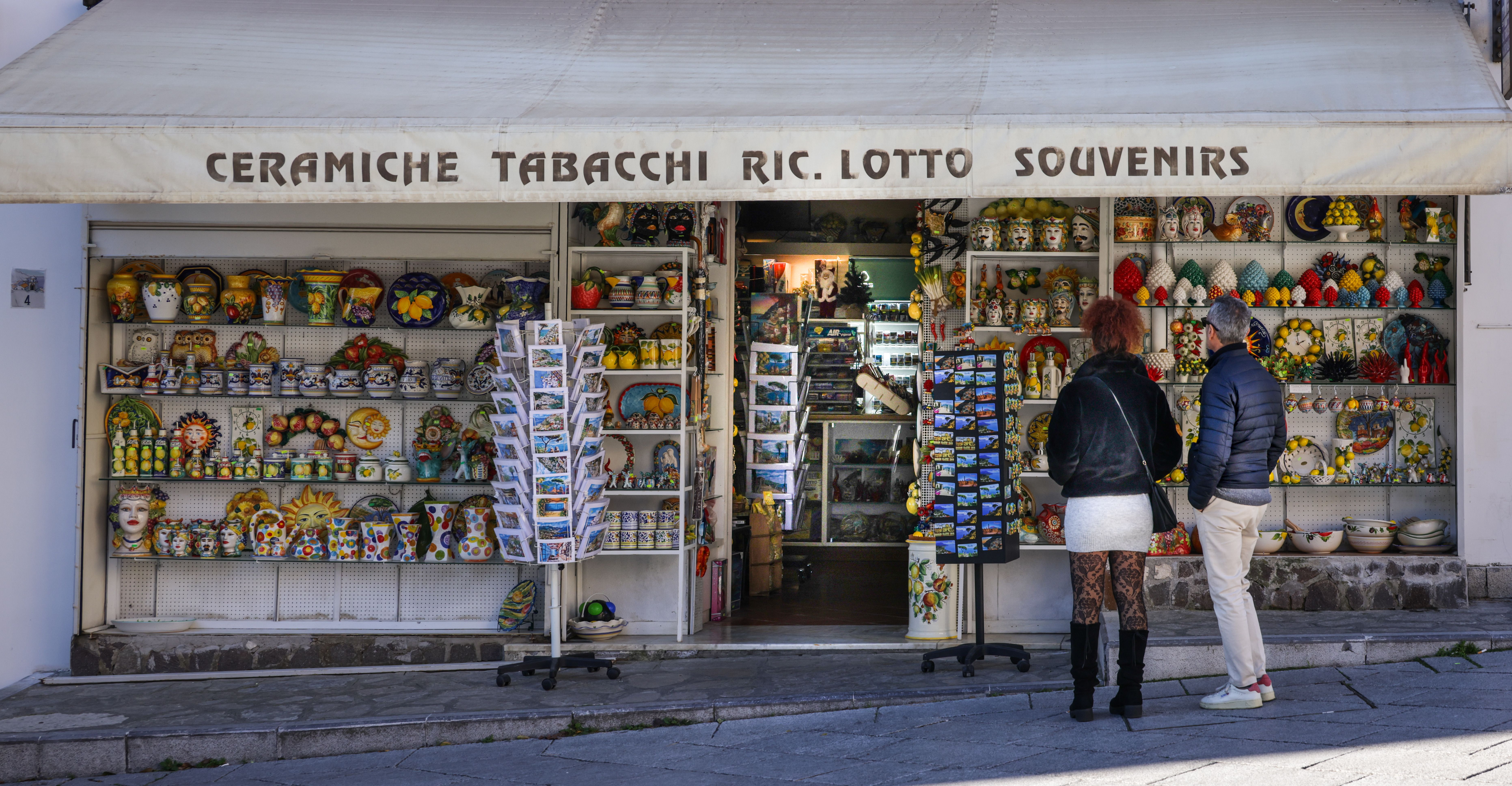 View of an Italian souvenir shop showcasing colorful ceramics and postcards.