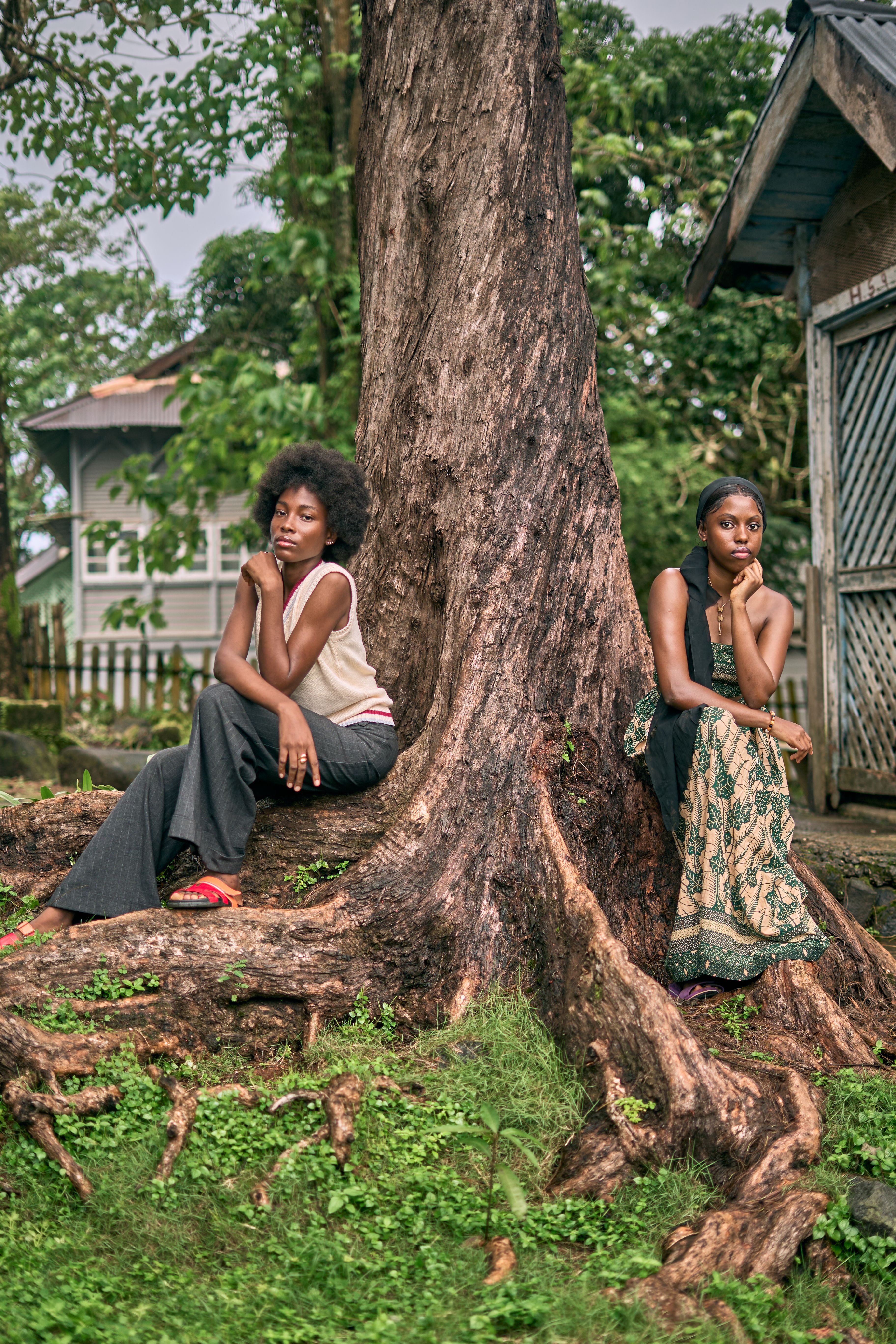 Two Women Posing Beside Majestic Tree Outdoors · Free Stock Photo
