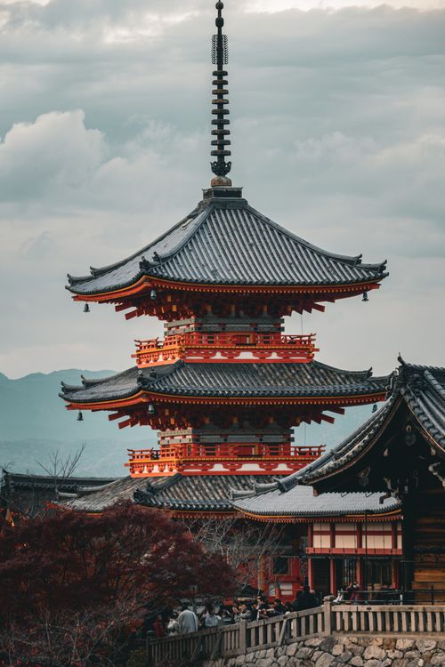 Free The iconic Kiyomizu-dera Temple in Kyoto, showcasing traditional Japanese architecture against a moody sky. Stock Photo