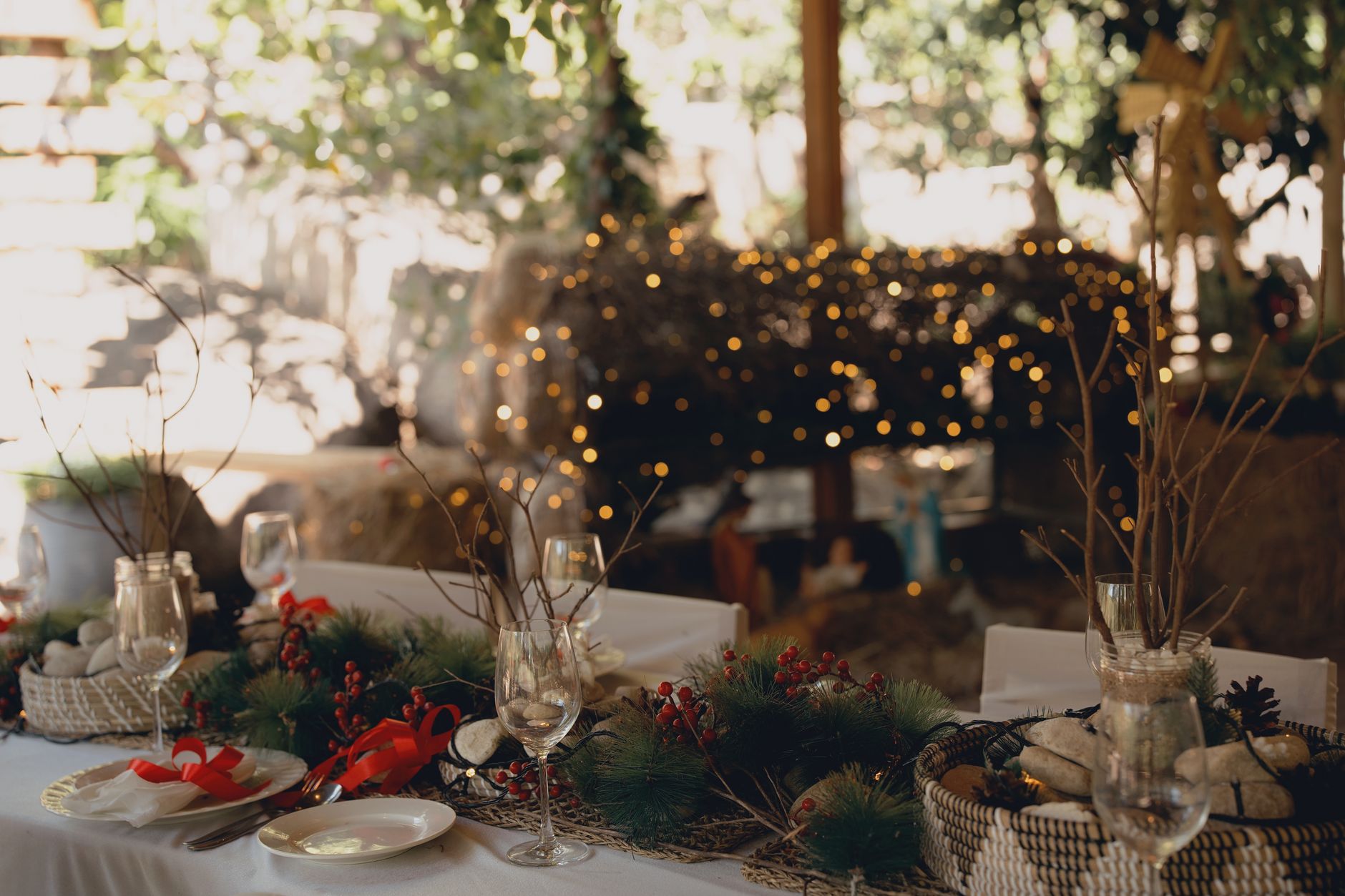 christmas event organizer cairo — An elegant outdoor table decorated with festive ornaments and warm lights for a holiday cel