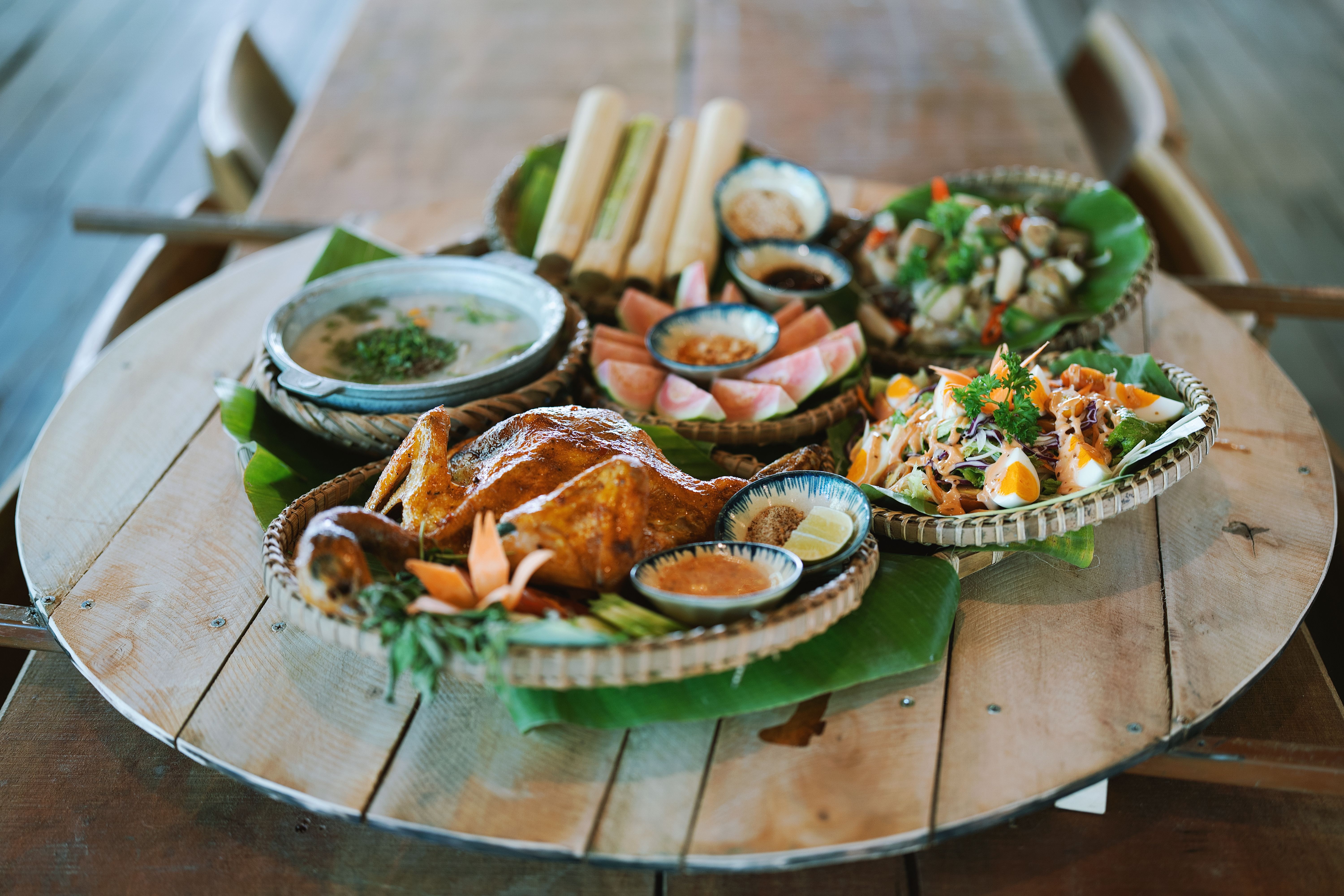 Traditional Asian Feast on Rustic Wooden Table · Free Stock Photo