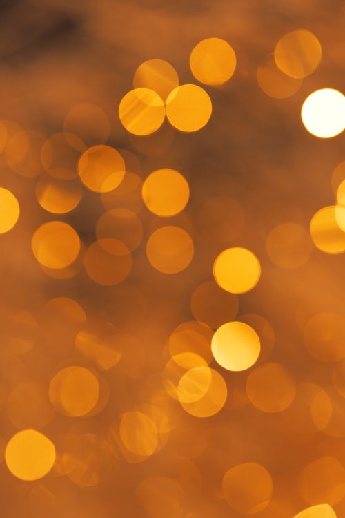 Free Golden bokeh lights create a warm and abstract background, perfect for festive and creative designs. Stock Photo