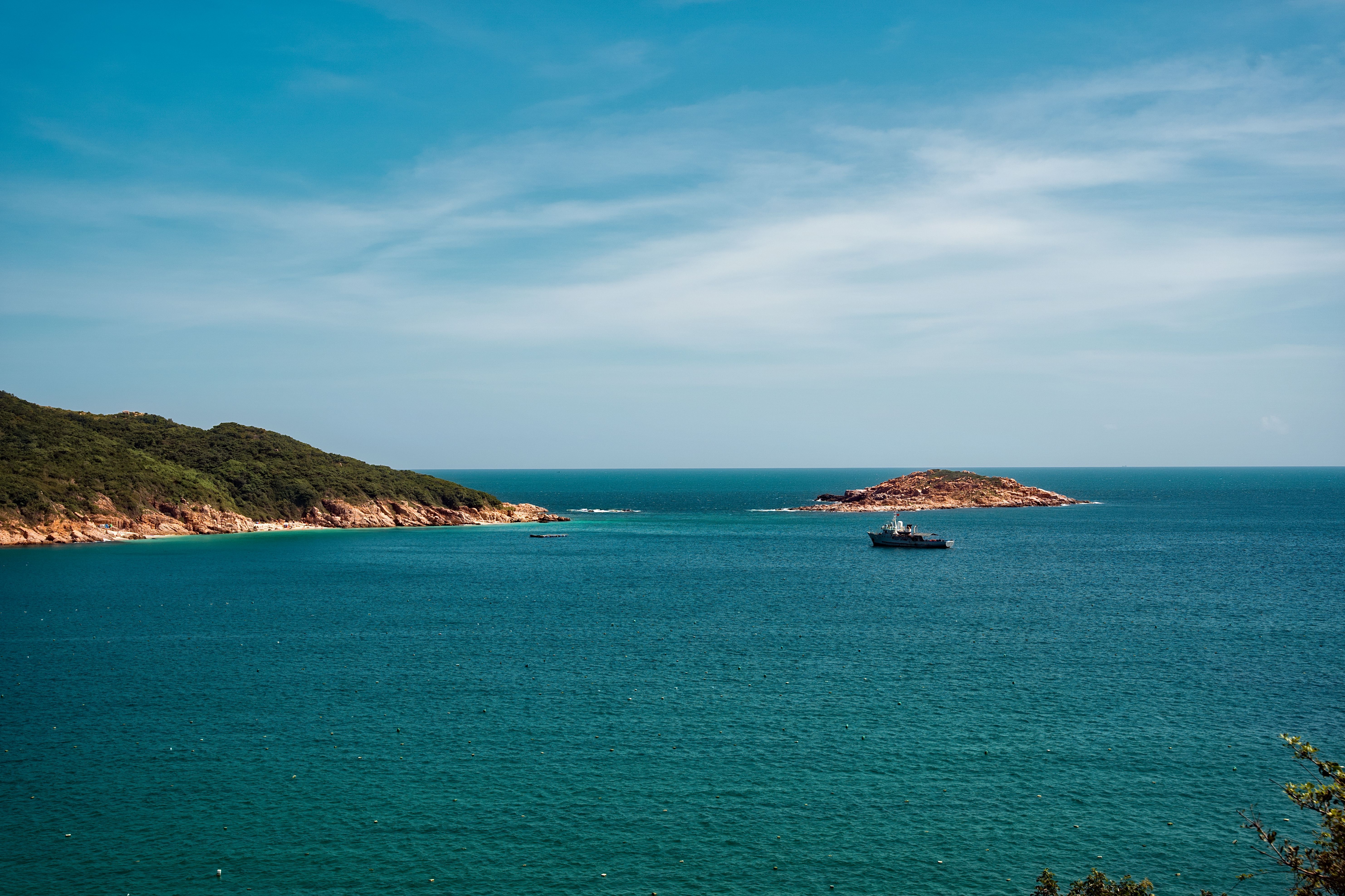 Serene Coastal Landscape with Boat and Island