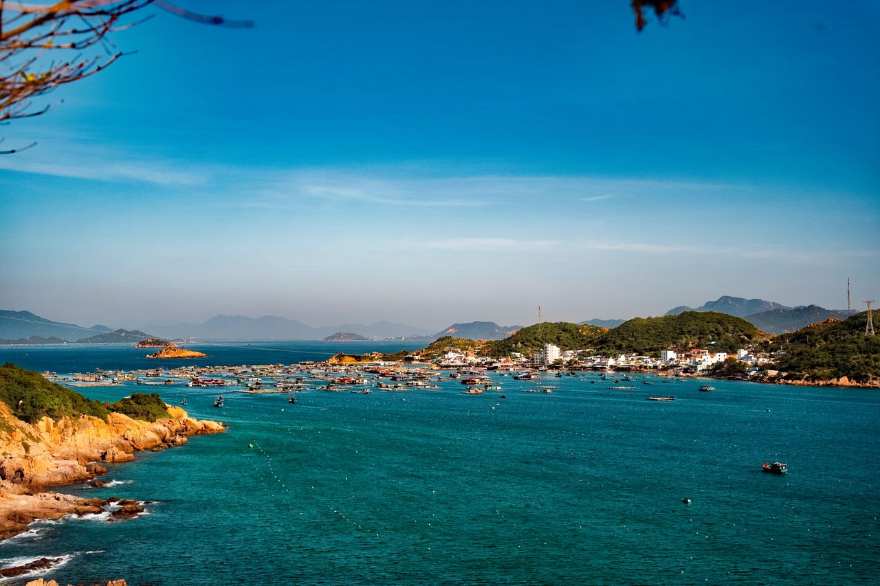 aerial view of a picturesque coastal fishing village with boats and cl