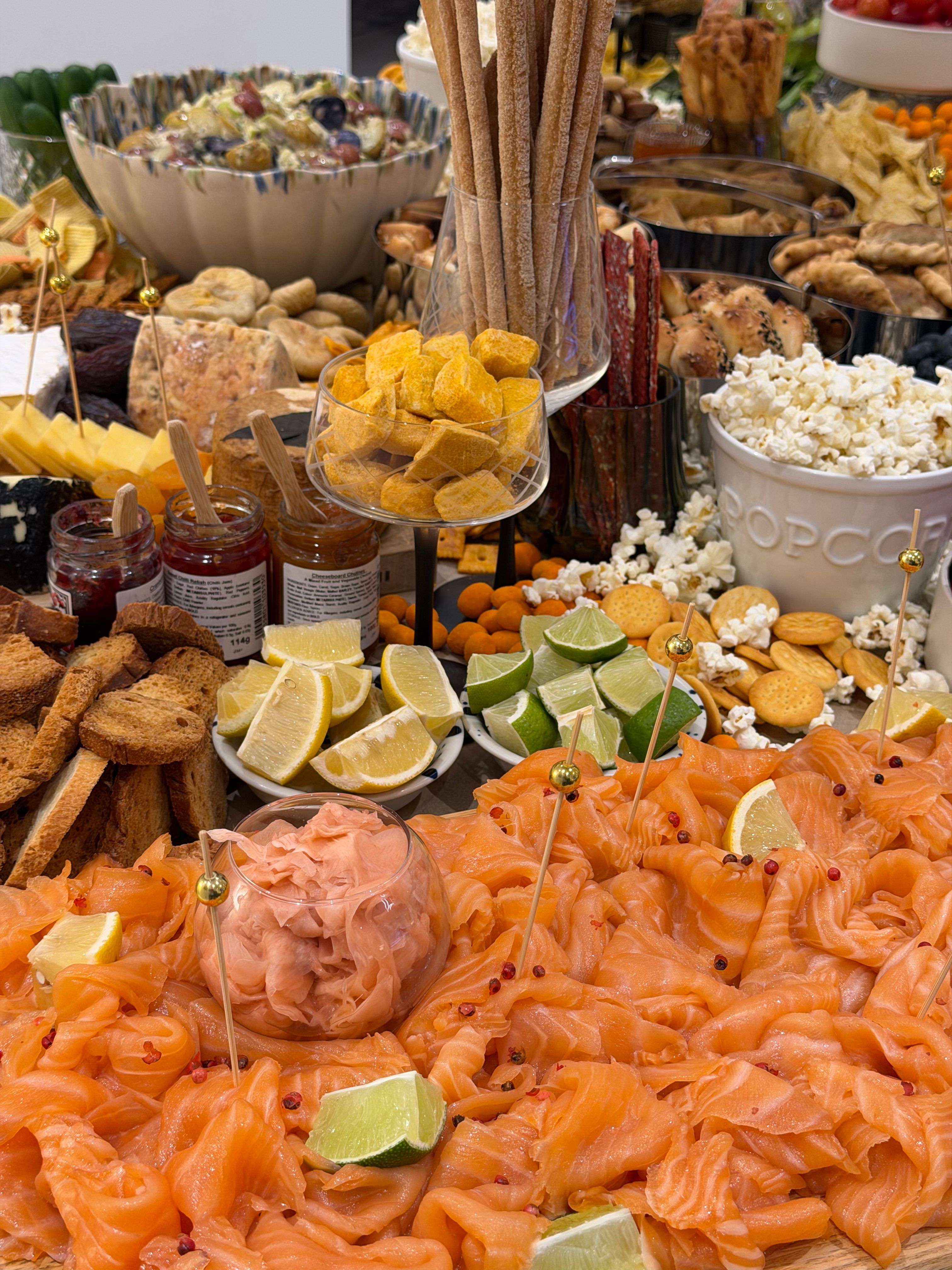 Grazing table with cheeses fruit and bread