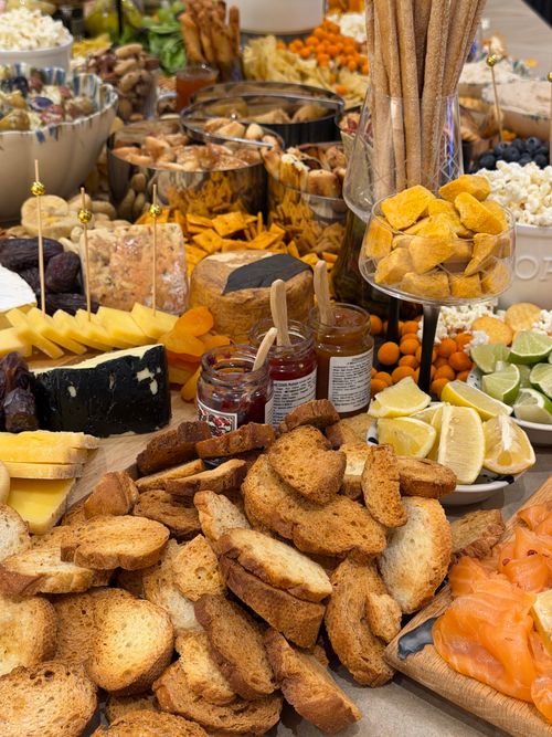 Free Diverse gourmet spread with bread, cheese, fruits, and meats. Stock Photo