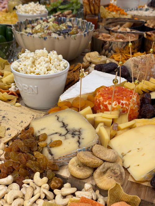 Free Gourmet cheese platter with assorted snacks, nuts, and popcorn for an elegant display. Stock Photo