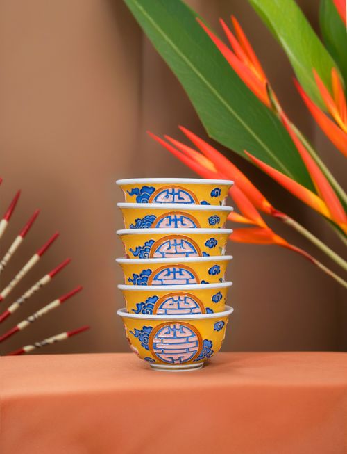 Free Vibrant stacked bowls with bird of paradise flowers in an artistic Asian decor setting. Stock Photo