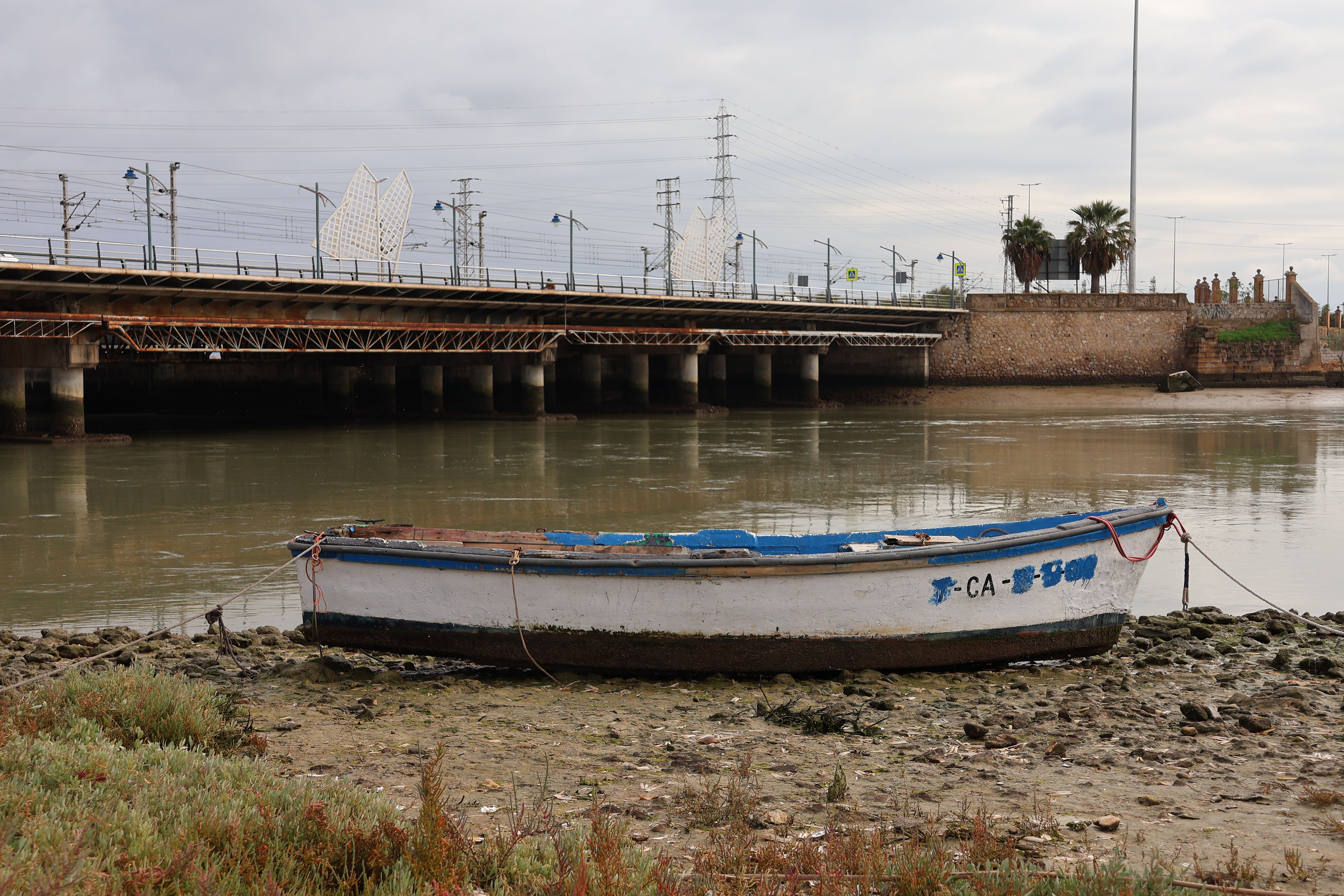 Tranquil boat scene by the bridge in El Puerto de Santa María, Spain.