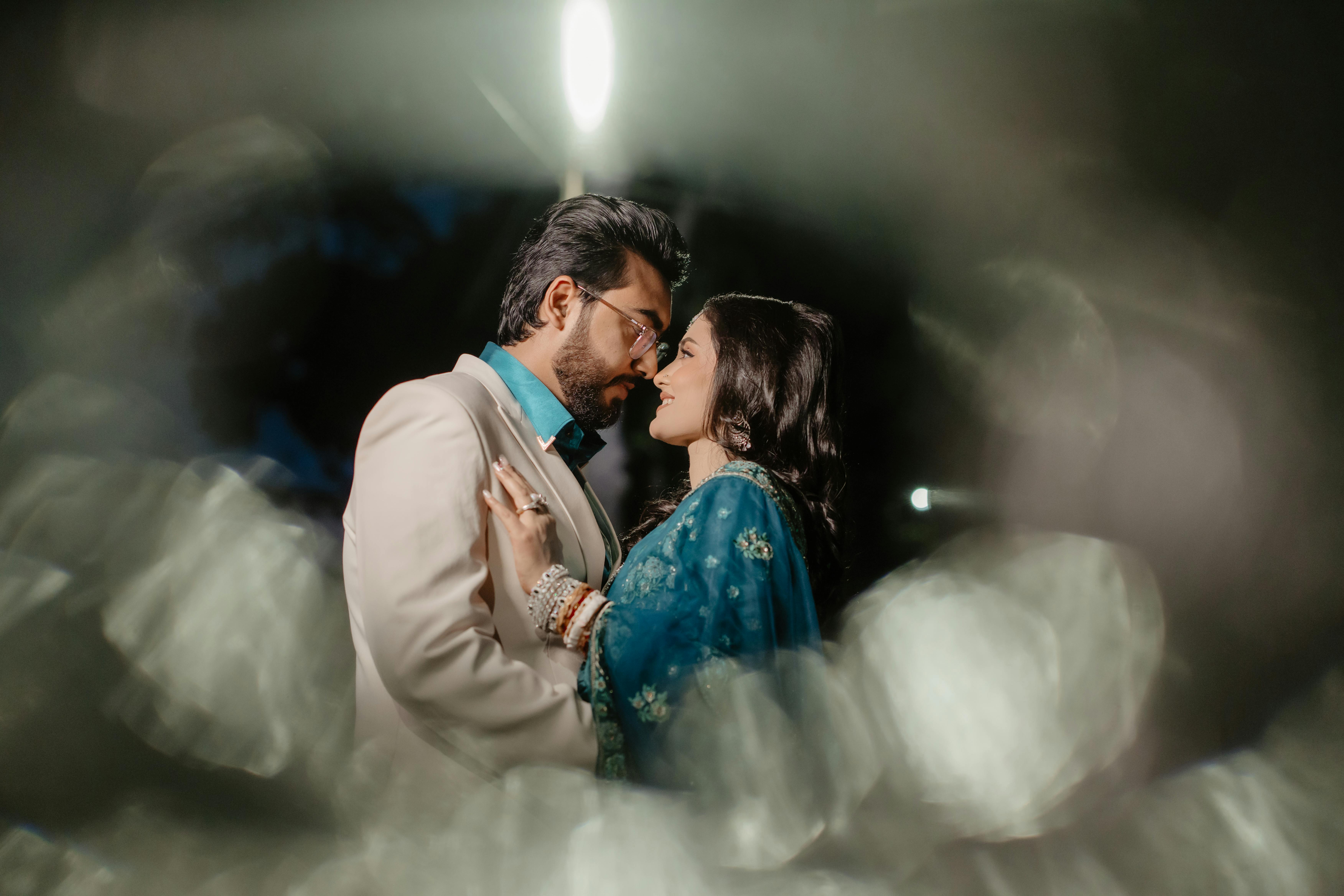Couple in tender embrace under moody light, symbolizing deep connection and post-climax closeness