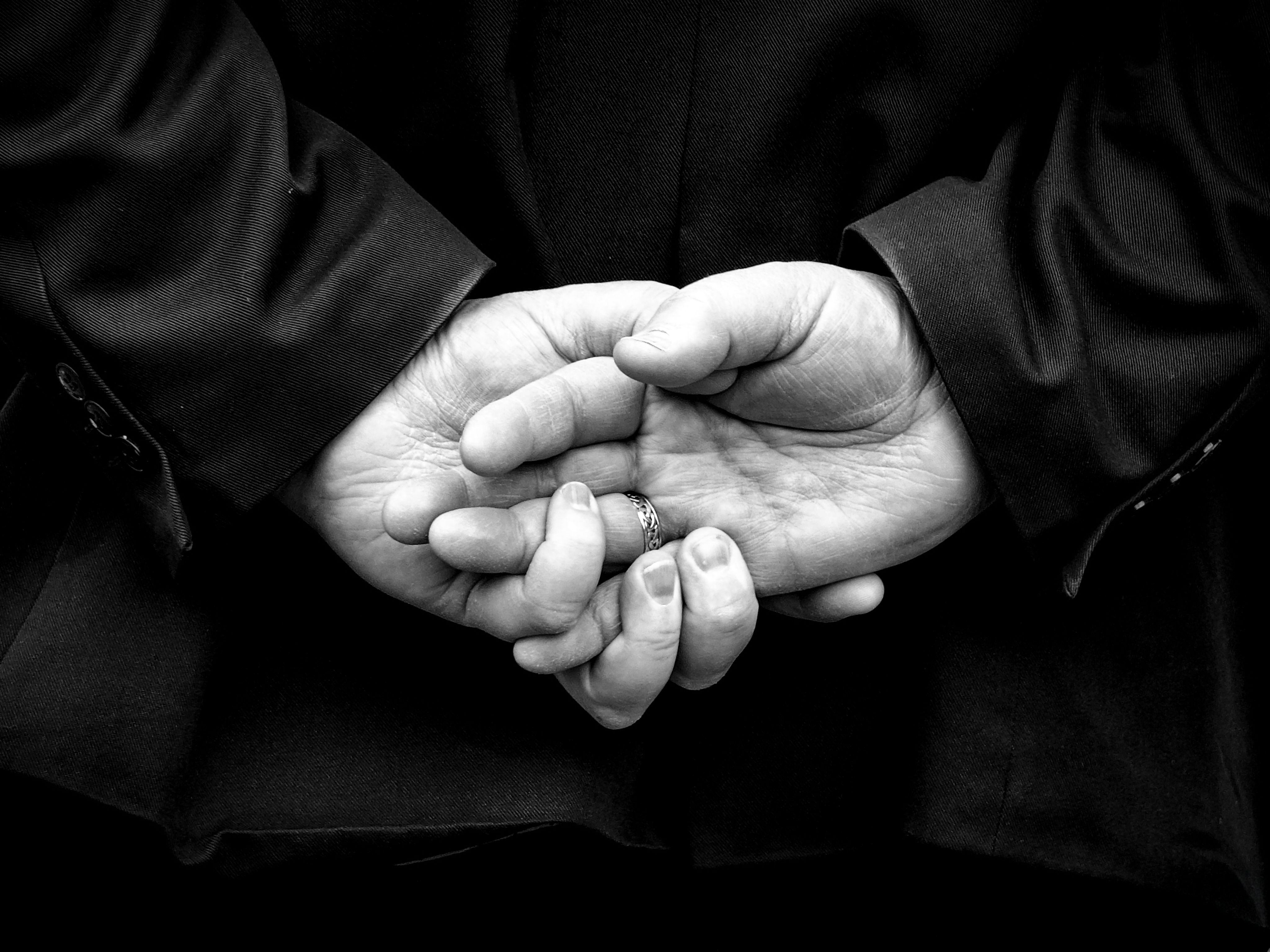 Black and White Close-Up of Clasped Hands · Free Stock Photo