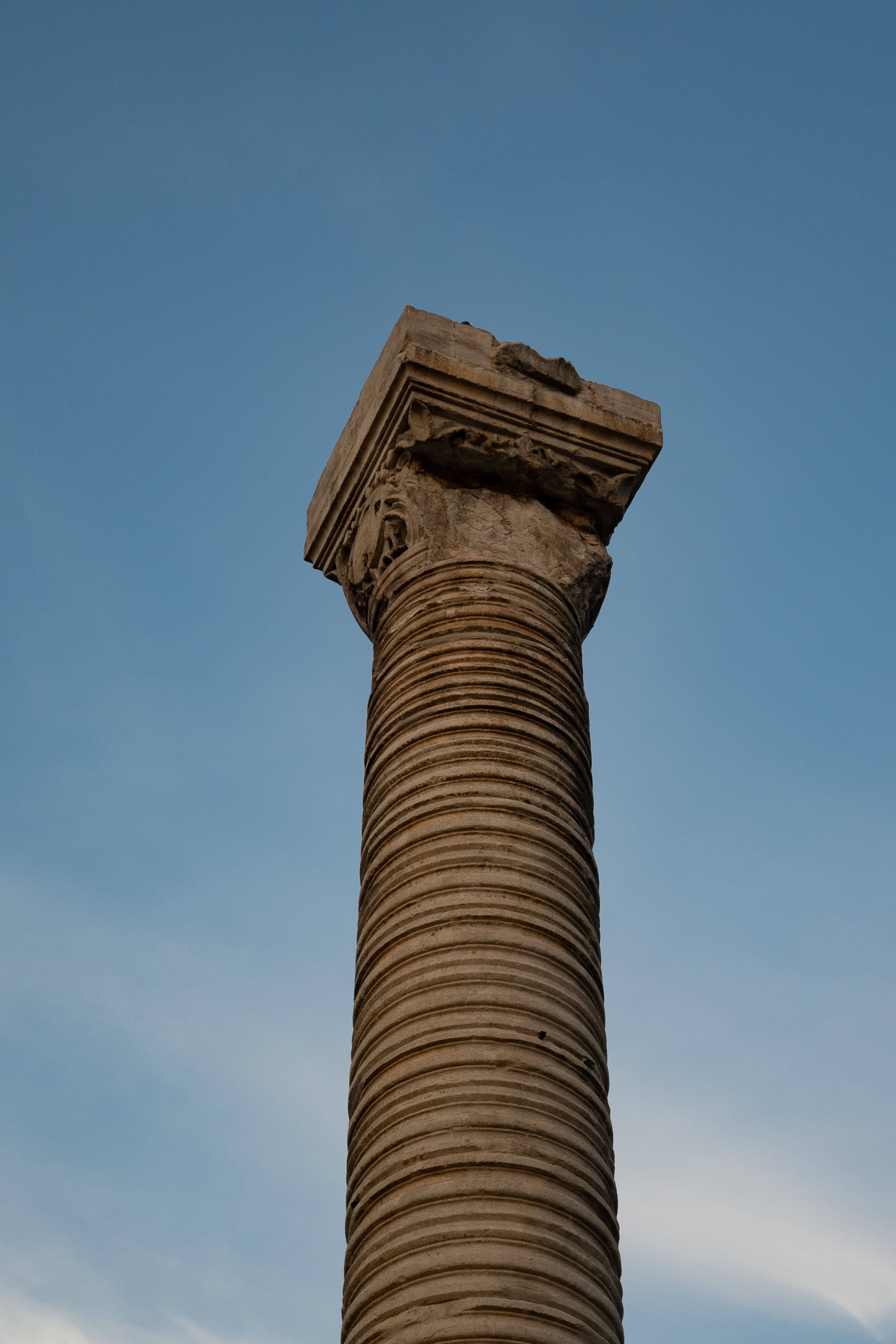 Ancient Stone Column Against Blue Sky · Free Stock Photo