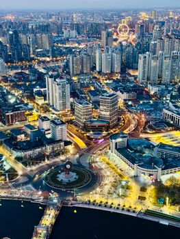 Breathtaking aerial shot of a city's skyline illuminated at night from above.