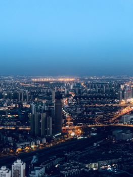 Breathtaking aerial cityscape with bright lights at twilight. Urban beauty.