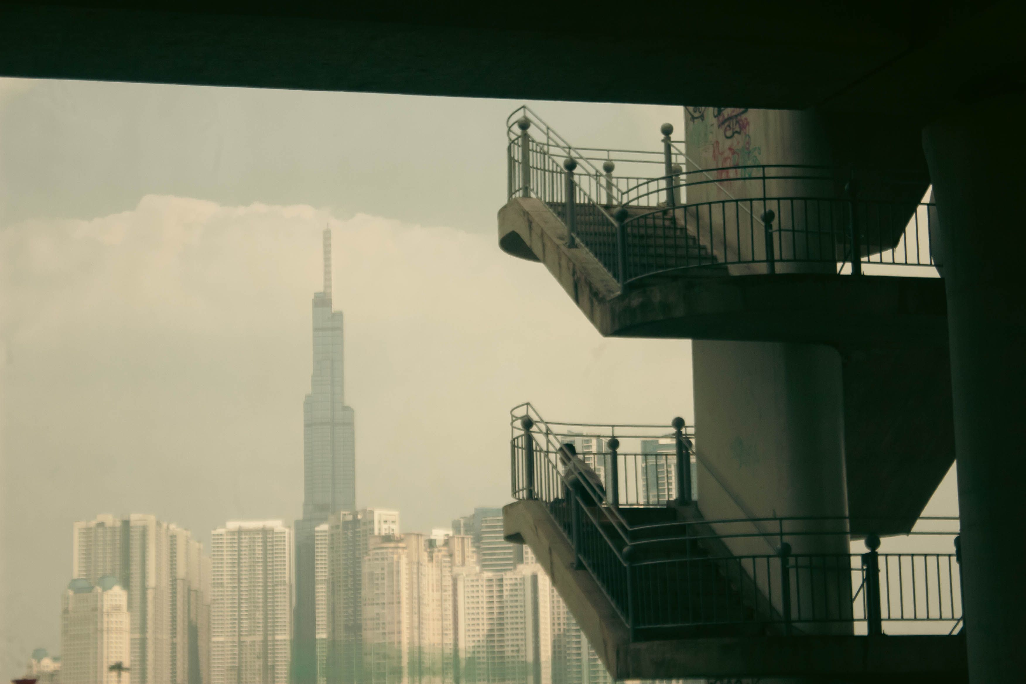 Skyline view featuring modern skyscrapers and a concrete stairwell.